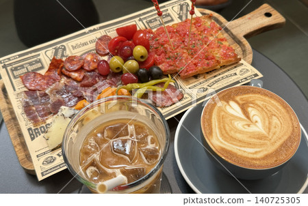 Delicious charcuterie board paired with aromatic coffee for a perfect brunch Delicious charcuterie board paired with aromatic coffee for a perfect brunch 140725305