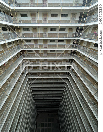 Unique perspective of a multi-story residential building with open courtyard Unique perspective of a multi-story residential building with open courtyard 140725320
