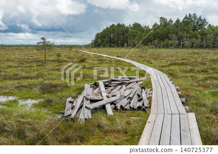 Repair of Dunika Bog Boardwalk in Latvia with New Wooden Footbridge Across Protected Wetland Area Repair of Dunika Bog Boardwalk in Latvia with New Wooden Footbridge Across Protected Wetland Area 140725377