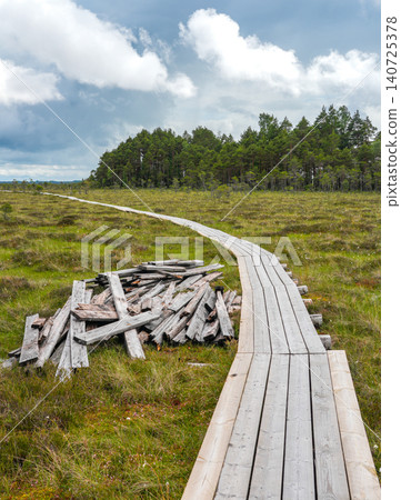 Dunika Bog Boardwalk Repair in Latvia with New Wooden Footbridge and Removed Old Timber Materials Dunika Bog Boardwalk Repair in Latvia with New Wooden Footbridge and Removed Old Timber Materials 140725378