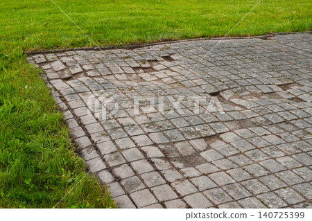 Uneven Sunken Concrete Paver Surface Caused by Ground Settlement and Poor Base Preparation 140725399