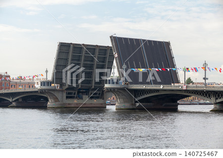 A large drawbridge lifts its spans over Neva river. St-Petersburg A large drawbridge lifts its spans over Neva river. St-Petersburg 140725467