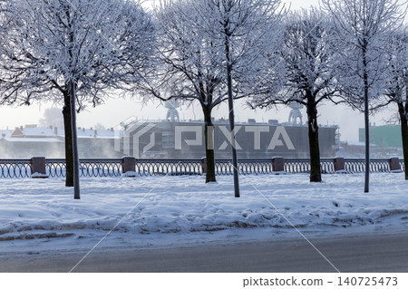 A tranquil winter scene along a snow-covered riverside A tranquil winter scene along a snow-covered riverside 140725473