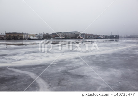 A wide frozen Neva river and icy waterfront. Saint-Petersburg 140725477