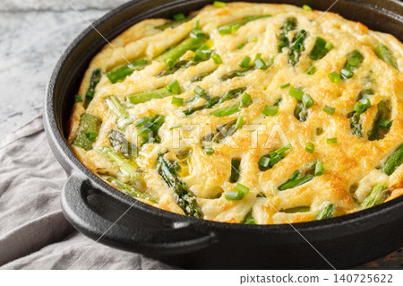 Delicious Green Asparagus Frittata with Fresh Herbs closeup in the skillet. Horizontal Delicious Green Asparagus Frittata with Fresh Herbs closeup in the skillet. Horizontal 140725622