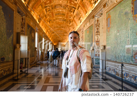 Medium shot portrait of young man standing inside historic gallery Medium shot portrait of young man standing inside historic gallery 140726237