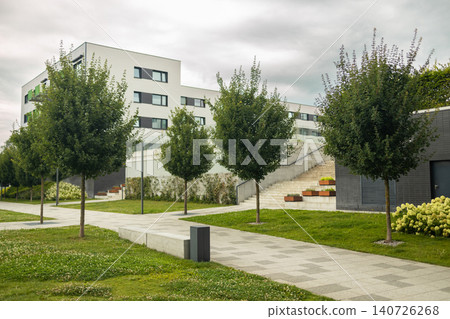 Modern apartment building courtyard with green lawns and trees Modern apartment building courtyard with green lawns and trees 140726268
