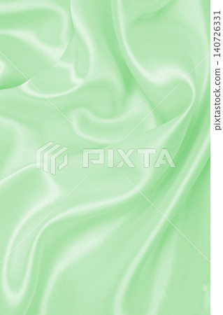Smooth elegant green silk or satin luxury cloth texture as abstract background. Luxurious background design 140726331