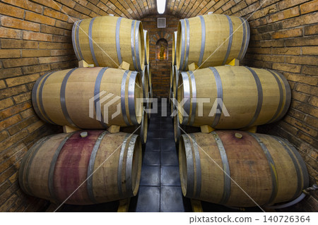 Wine barrels aging in a traditional brick cellar Wine barrels aging in a traditional brick cellar 140726364