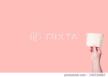 Classic menstrual pads in woman hand. Menstrual cycle and suffering from menstrual pain. Female period and intimate hygiene Classic menstrual pads in woman hand. Menstrual cycle and suffering from menstrual pain. Female period and intimate hygiene 140726867