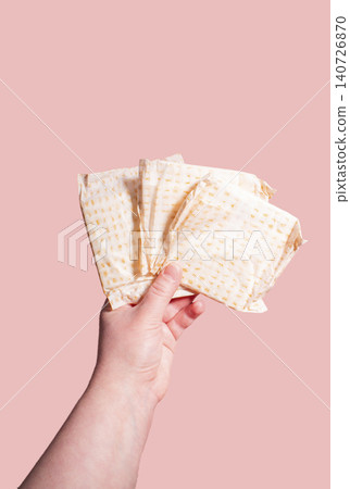 White sanitary pads in hand. Concept of menstruation, ovulation, reproduction, pain and personal feminine hygiene White sanitary pads in hand. Concept of menstruation, ovulation, reproduction, pain and personal feminine hygiene 140726870