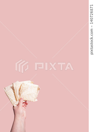 Classic menstrual pads in woman hand. Menstrual cycle and suffering from menstrual pain. Female period and intimate hygiene Classic menstrual pads in woman hand. Menstrual cycle and suffering from menstrual pain. Female period and intimate hygiene 140726871