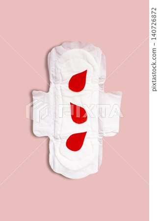Menstrual pad with red drops on pink background. Menstruation cycle period, woman hygiene and comfort concept Menstrual pad with red drops on pink background. Menstruation cycle period, woman hygiene and comfort concept 140726872