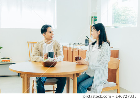 A young couple relaxing at the dining room A young couple relaxing at the dining room 140727335
