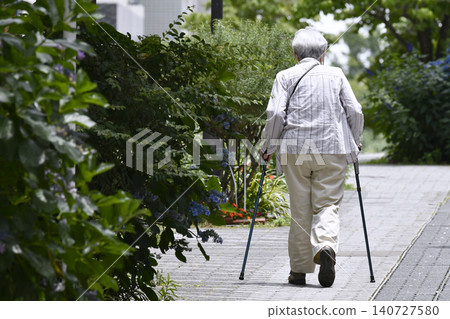 The urban landscape of Yokohama, Japan: A street lined with paved sidewalks and canes... For some reason, there seem to be a lot of elderly women (in macho attire) using canes. The urban landscape of Yokohama, Japan: A street lined with paved sidewalks and canes... For some reason, there seem to be a lot of elderly women (in macho attire) using canes. 140727580