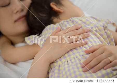 A mother holding her one-year-old daughter. A mother holding her one-year-old daughter. 140728773