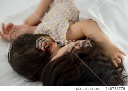 A mother holding her one-year-old daughter. A mother holding her one-year-old daughter. 140728776