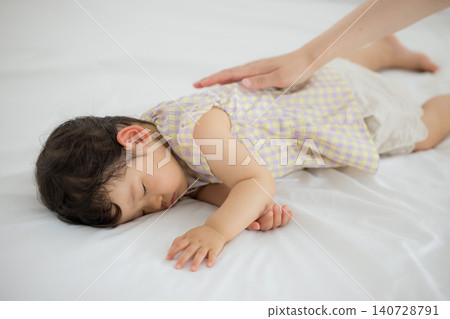 A one-year-old girl taking a nap A one-year-old girl taking a nap 140728791