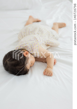 A one-year-old girl taking a nap A one-year-old girl taking a nap 140728798