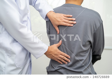 Physical therapy, Asian therapist doctor treat perform pain young man in hospital. Physical therapy, Asian therapist doctor treat perform pain young man in hospital. 140728889