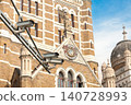 Mumbai Maharashtra India Jan 18 2026 Modern white CCTV surveillance cameras mounted on a metal arm overlooking the historic facade and ornate carvings of the BMC building. 140728993