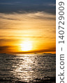 Mumbai Maharashtra India Jan 18 2026 Dramatic golden sunset over the Arabian Sea with glowing reflections on waves and distant ships along the Mumbai coast 140729009