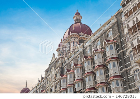 Mumbai Maharashtra India Jan 18 2026 Ornate red domes and grey stone architectural details of the historic Taj Mahal Palace Hotel building against a bright blue sky in South Mumbai Mumbai Maharashtra India Jan 18 2026 Ornate red domes and grey stone architectural details of the historic Taj Mahal Palace Hotel building against a bright blue sky in South Mumbai 140729013