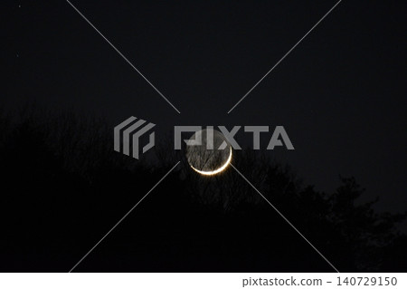 A thin crescent moon sinking into the forest A thin crescent moon sinking into the forest 140729150