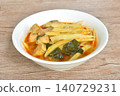 spicy boiled slice fresh bamboo shoot with pork in coconut milk Thai red curry soup on bowl 140729231