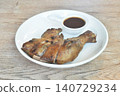 roasted chicken tight and leg with black pepper on plate dipping with spicy tamarind sauce 140729234