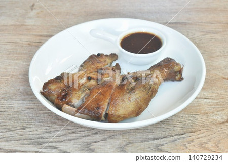 roasted chicken tight and leg with black pepper on plate dipping with spicy tamarind sauce 140729234