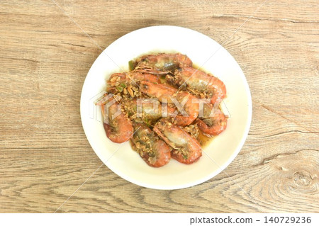deep fried salty river shrimp with chop garlic and chili pepper arranging on plate  140729236