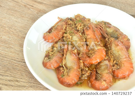 deep fried salty river shrimp with chop garlic and chili pepper arranging on plate  140729237