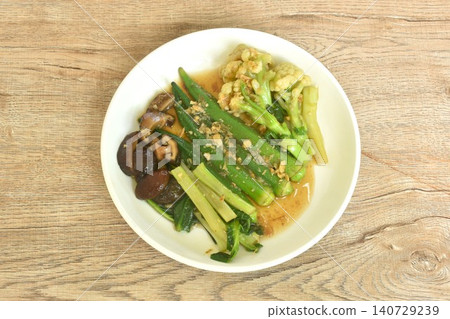 stir fried cauliflower and roselle with cabbage topping black mushroom in gravy garlic soy sauce on plate 140729239