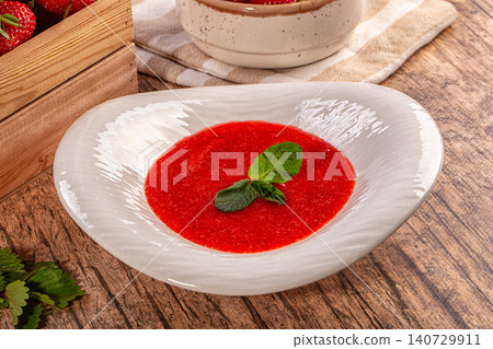 Sweet strawberry soup with fresh mint garnish on rustic wooden table Sweet strawberry soup with fresh mint garnish on rustic wooden table 140729911