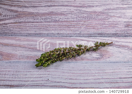 Fresh thyme sprig on rustic purple and gray wood background Fresh thyme sprig on rustic purple and gray wood background 140729918
