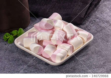 Pink and white marshmallows on square plate with coffee pot 140729988