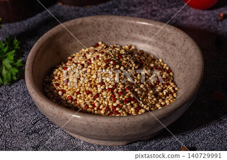 Raw quinoa seeds in ceramic bowl with fresh parsley and tomatoes 140729991