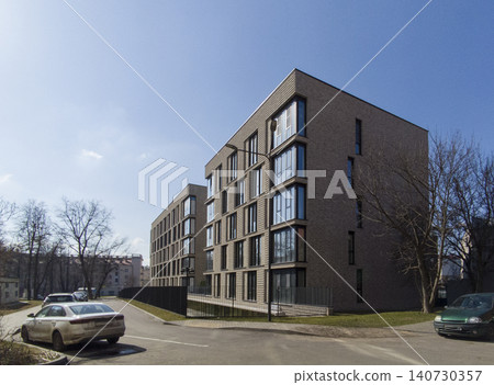 Modern residential building in constructivism style with clean geometric facade. Apartment structure shows minimal design and urban composition 140730357
