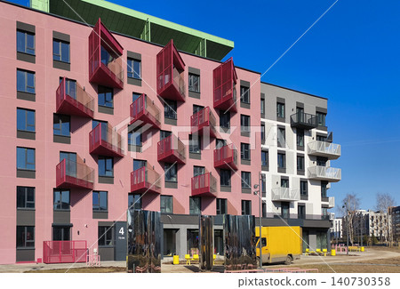 Modern residential building with colorful balconies and geometric facade design. Apartment structure shows bold composition and contemporary architecture style. Concept of housing Modern residential building with colorful balconies and geometric facade design. Apartment structure shows bold composition and contemporary architecture style. Concept of housing 140730358