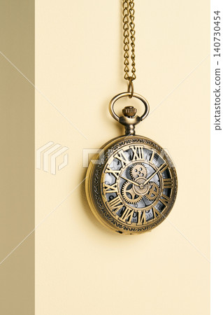 Antique pocket watch on a simple background. Antique pocket watch on a simple background. 140730454
