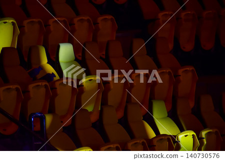 Empty chairs in the stadium. Empty seats in the stadium. Sport background pattern photo. Patterns of chairs in a theater. Seats background pattern photo.  140730576