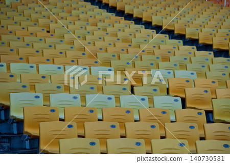 Empty chairs in the stadium. Empty seats in the stadium. Sport background pattern photo. Patterns of chairs in a theater. Seats background pattern photo. Empty chairs in the stadium. Empty seats in the stadium. Sport background pattern photo. Patterns of chairs in a theater. Seats background pattern photo. 140730581