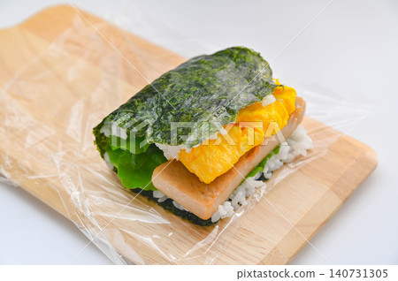 Homemade pork and egg onigirazu (rice ball sandwich) - currently being prepared. Homemade pork and egg onigirazu (rice ball sandwich) - currently being prepared. 140731305