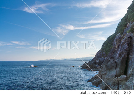 A breathtaking view of the cliffs of Onigajo, a World Heritage Site, and the Kumano Sea, under a clear blue sky. A breathtaking view of the cliffs of Onigajo, a World Heritage Site, and the Kumano Sea, under a clear blue sky. 140731830