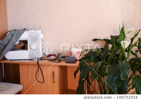 A fashion designer's workspace with a sewing machine in the studio A fashion designer's workspace with a sewing machine in the studio 140732058