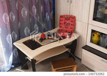 Tools and materials are arranged on a work surface for a home repair task in a workshop setting Tools and materials are arranged on a work surface for a home repair task in a workshop setting 140732062
