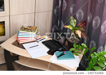 Modern empty freelancer or student work table with laptop, wireless headphones and documents in folders at home Modern empty freelancer or student work table with laptop, wireless headphones and documents in folders at home 140732068