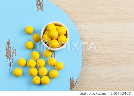 Tasty lemon drops on wooden table, flat lay. Space for text Tasty lemon drops on wooden table, flat lay. Space for text 140732407