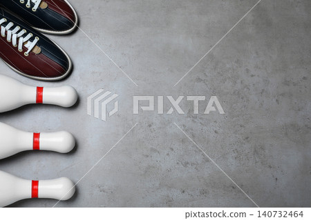 Bowling shoes and pins on grey stone table, flat lay. Space for text Bowling shoes and pins on grey stone table, flat lay. Space for text 140732464